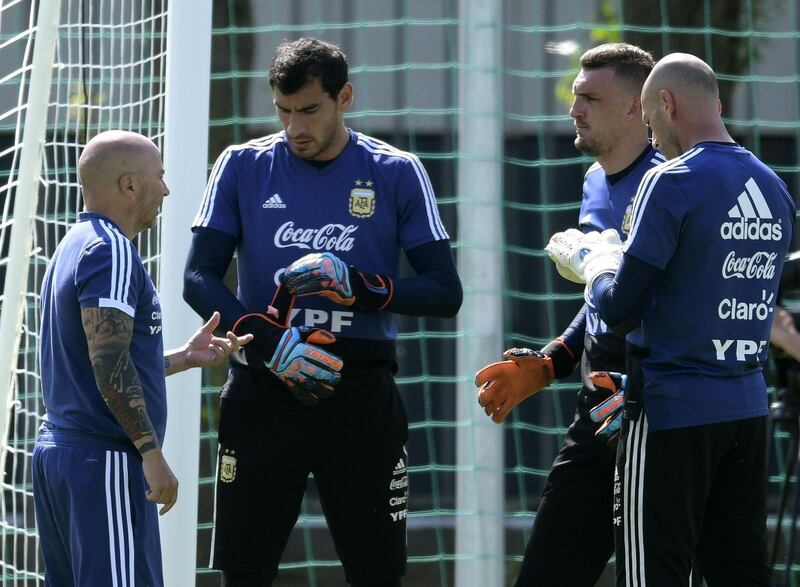 Argentina's coach Jorge Sampaoli, left, talks to goalkeepers Nahuel Guzman, second left,  Franco Armani and Wilfredo Caballero during a training session. AFP