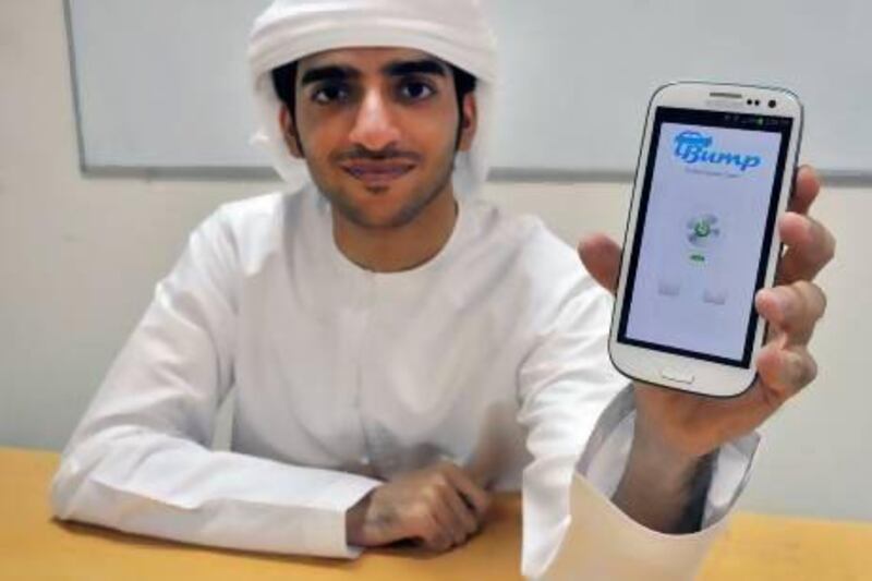 Humaid Al Ali with a phone running iBump, the app he created with a fellow student at the American University of Sharjah. Charles Crowell for The National