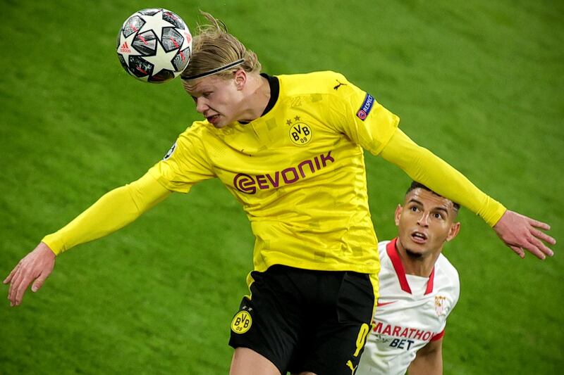 epa09064298 Dortmund's Erling Haaland (L) in action against Sevilla's Diego Carlos (R) during the UEFA Champions League round of 16 second leg soccer match between Borussia Dortmund and Sevilla FC in Dortmund, Germany, 09 March 2021.  EPA/FRIEDEMANN VOGEL / POOL