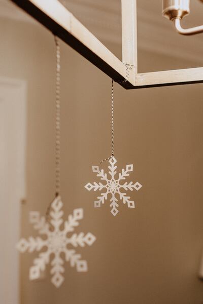 Paper snowflakes simply require some white paper and a pair of scissors. Photo: Kelly Sikkema / Unsplash