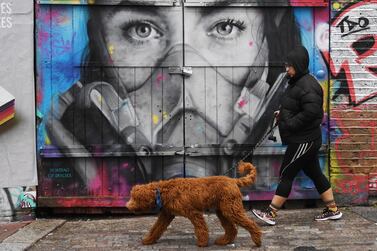 A walker passes a Covid themed grafitti in the Tower Hamlet area of London, Britain. UK finance minister Rishi Sunak’s original furlough programme will be replaced by a less-generous Job Support Scheme on November 1. EPA