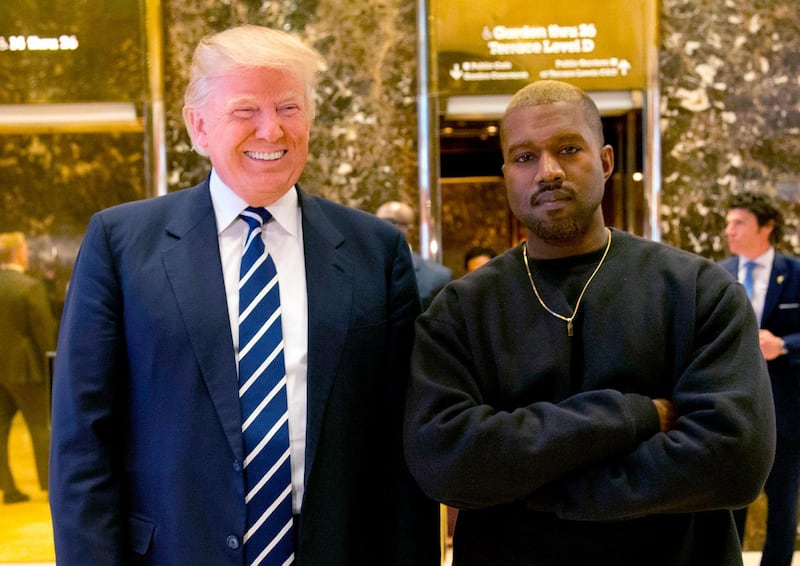 FILE - In this Dec. 13, 2016, file photo, then-President-elect Donald Trump and Kanye West pose for a picture in the lobby of Trump Tower in New York. Trump is tweeting his thanks to rap superstar Kanye West for his recent online support. Trump wrote, â€œThank you Kanye, very cool!â€ in response to the tweets from West, who called the president â€œmy brother.â€ West tweeted a number of times Wednesday expressing his admiration for Trump, saying they both share â€œdragon energy.â€ The rap star also posted a photo of himself wearing Trumpâ€™s campaign â€œMake America Great Againâ€ hat. (AP Photo/Seth Wenig, File)