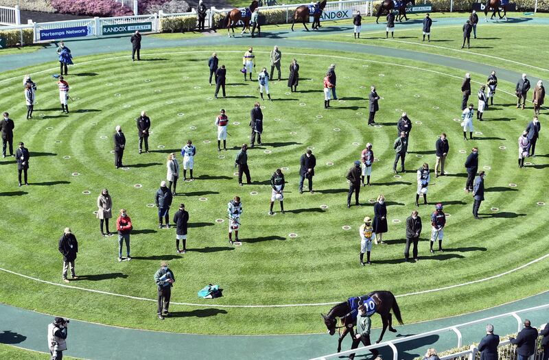 Jockeys and trainers observe a minute of silence in Aintree. EPA