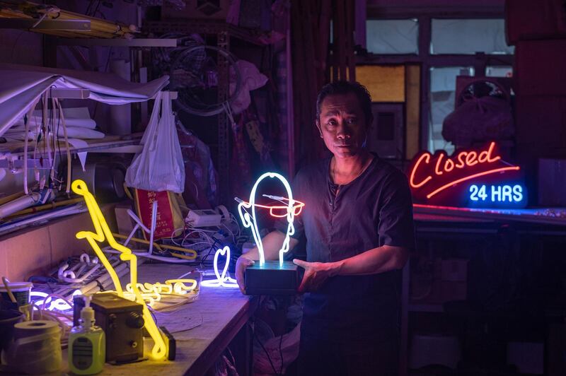 In this picture taken on April 16, 2018, neon sign maker Wu Chi-kai poses during an interview with AFP in Hong Kong.
Neon sign maker Wu Chi-kai is one of the last remaining craftsmen of his kind in Hong Kong, a city where darkness never really falls thanks to the 24-hour glow of a myriad lights. 
Ahead of May Day, AFP's video and photo teams spoke to men and women around the globe whose jobs are becoming increasingly rare, particularly as technology transforms societies. / AFP PHOTO / Philip FONG / PHOTO ESSAY ON 'DISAPPEARING JOBS' MORE PHOTOS AVAILABLE ON AFPFORUM.COM