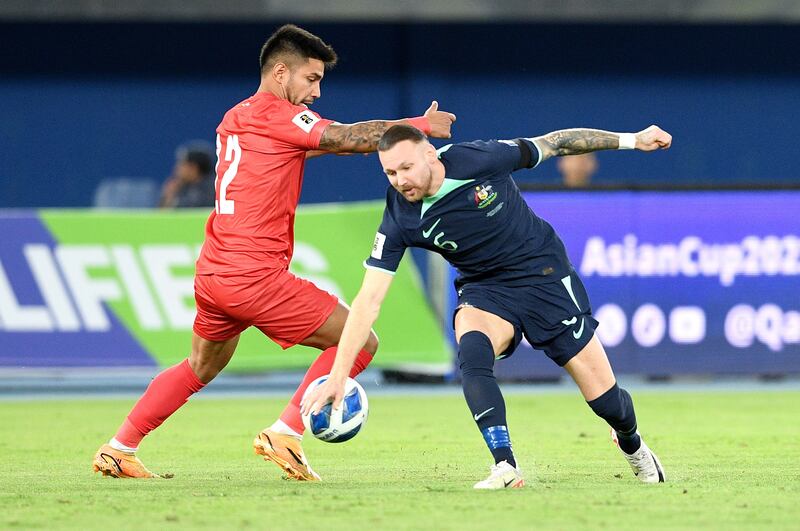 Jonathan Cantillana of Palestine fights for the ball with Martin Boyle of Australia in Kuwait. EPA
