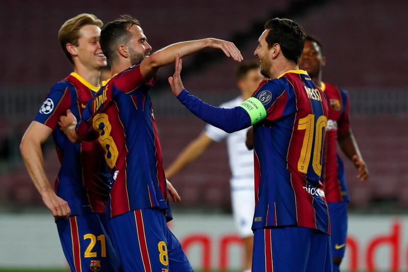 Barcelona's Lionel Messi with teammates after scoring from the penalty spot. AP