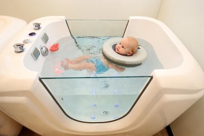 Abu Dhabi, United Arab Emirates - June 30, 2019: Arthur Cook who is 6 months old has hydrotherapy treatment and baby massage from Jacquelyn Pe–a at Baby Spa in Abu Dhabi. Sunday the 30th of June 2019. Yes Mall, Abu Dhabi. Chris Whiteoak / The National