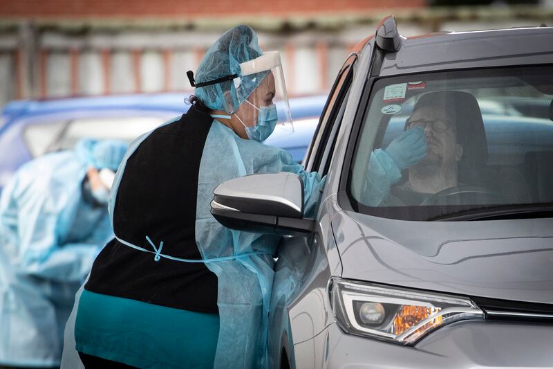 Workers take samples for Covid-19 tests at a drive-through clinic in Auckland, New Zealand. AP