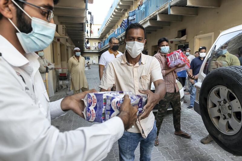 The Sri Lanka community distributes three hundred / 300 meals to workers at the Fakhruddin Camp in Sonapur, Dubai with the help of the to Al Watani volunteers and the CDA on April 23 rd, 2021. 
Antonie Robertson / The National.
Reporter: Ramola Talwar for National