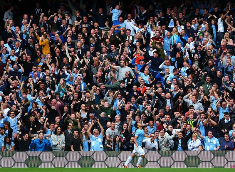 MANCHESTER, ENGLAND - OCTOBER 05:  Manchester City fans celebrate after Sergio Aguero of Manchester City scores their team's second goal during the Barclays Premier League match between Manchester City and Everton at Etihad Stadium on October 5, 2013 in Manchester, England.  (Photo by Michael Steele/Getty Images)