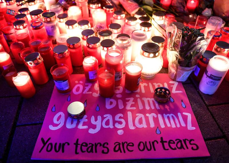 A sign between candles and flowers reads 'your tears are our tears' after a vigil for the victims of the shooting in Hanau, Germany. A 43-year-old German man shot and killed several people at several locations in a Frankfurt suburb overnight in attacks that appear to have been motivated by far-right beliefs, officials said Thursday. AP Photo