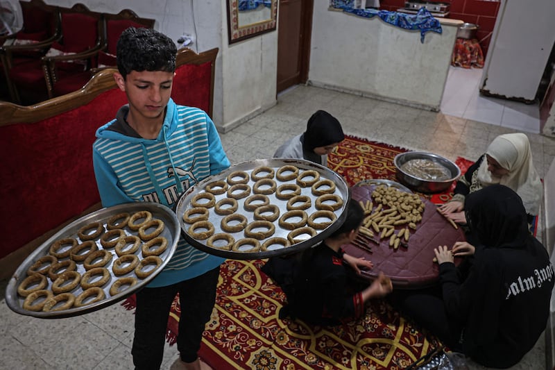 A Palestinian family prepares food for Eid Al Fitr. AFP