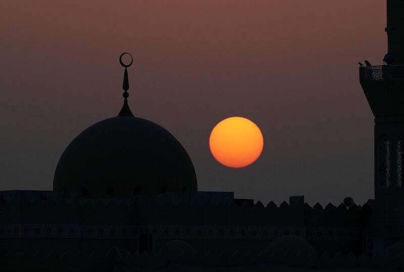 Abu Dhabi, United Arab Emirates - May 31st, 2018: Standalone. The sun sets over a mosque during Ramadan. Thursday, May 31st, 2018 at Al Bahya, Abu Dhabi. Chris Whiteoak / The National