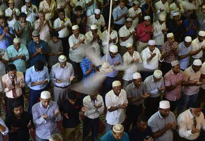 Sri Lankan Muslim men pray during Friday noon prayers at a mosque in Colombo on May 17, 2019. Sri Lanka's minority Muslims attended Friday prayers on May 17 as heavily armed troops and police guarded all mosques, including those badly vandalised in riots in the wake of the Easter terror attacks.
 / AFP / LAKRUWAN WANNIARACHCHI
