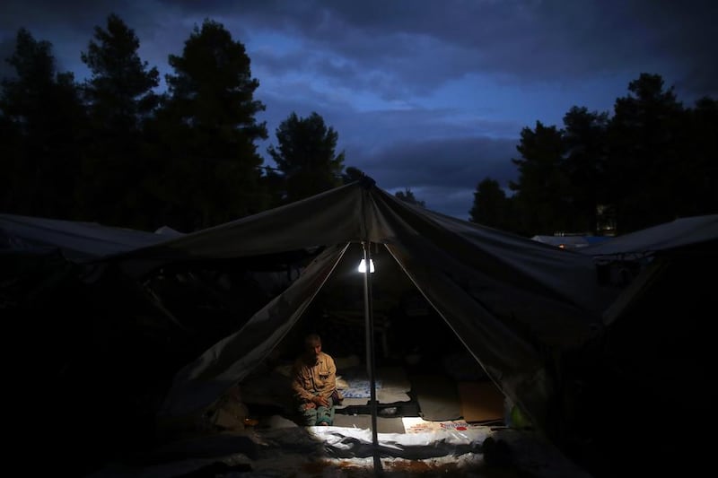 A Syrian man sits inside his tents at Ritsona refugee camp north of Athens, which hosts about 600 refugees and migrants. Petros Giannakouris / AP Photo