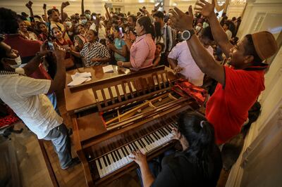 People sing songs inside the prime minister's official residence in Colombo, Sri Lanka, on July 11, two days after official residences were stormed.  EPA