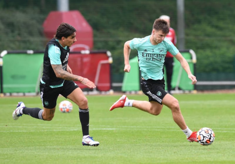 Hector Bellerin chases after Kieran Tierney at training.