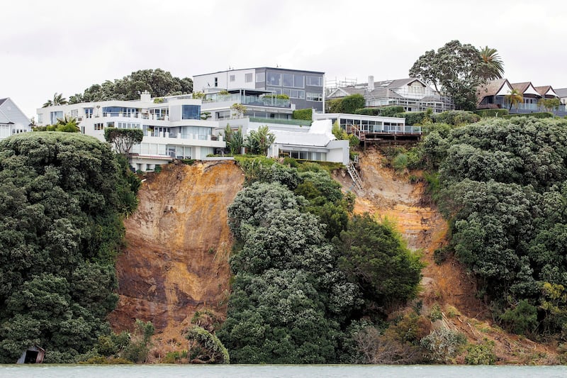 Clifftop houses near a slip caused by continuous bad weather in Auckland. Reuters
