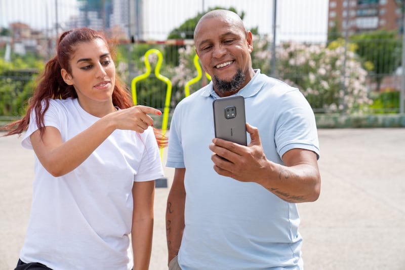 Football freestyler Lisa Zimouche and Brazil football great Roberto Carlos star in a new marketing campaign for Nokia