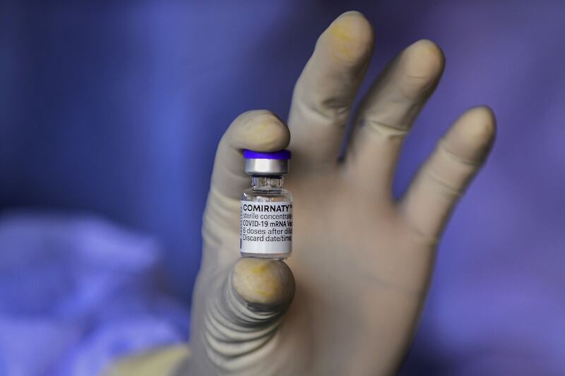 An army health workers displays a vial of the Pfizer-BioNTech vaccine in Colombo, Sri Lanka.