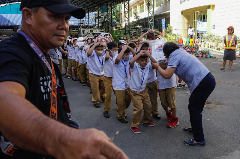 Pupils and teachers practise evacuation procedures during an earthquake drill at an elementary school in Quezon City, Philippines. EPA