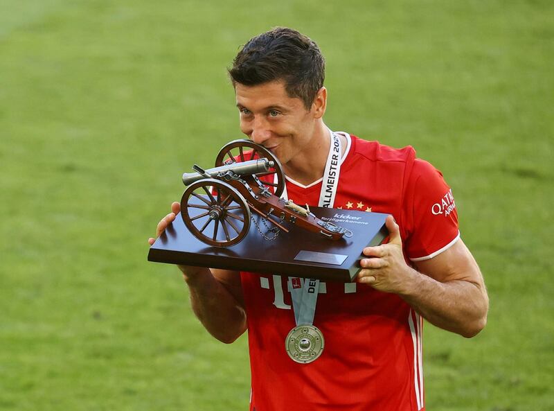 Bayern Munich striker Robert Lewandowski celebrates with the trophy after finishing as the Bundesliga's leading goalscorer. AFP