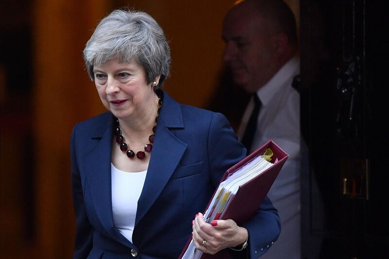 Britain's Prime Minister Theresa May leaves 10 Downing Street in London on November 14, 2018, to attend the weekly Prime Minister's Questions at the Houses of Parliamnet. British and European Union negotiators have reached a draft agreement on Brexit, Prime Minister Theresa May's office said on November 13.  / AFP / Ben STANSALL
