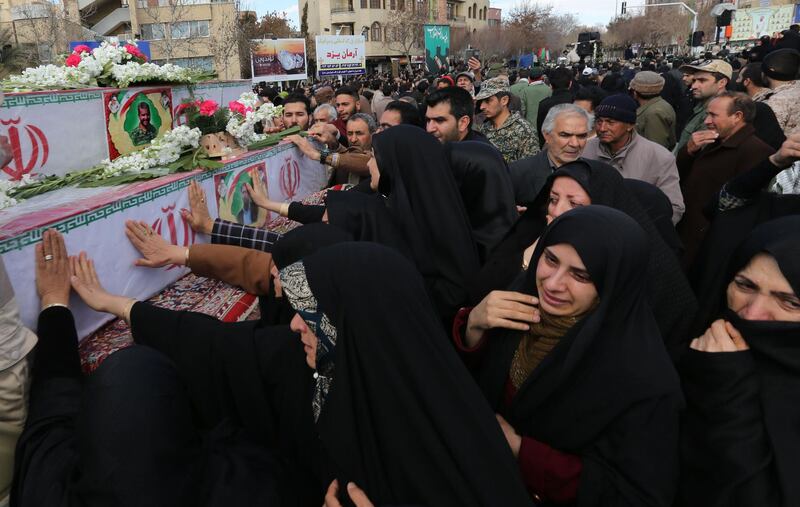 Iranian mourners gather around the coffins of Revolutionary Guards, killed in a suicide attack, during their funeral in the southeastern city of Isfahan. AFP