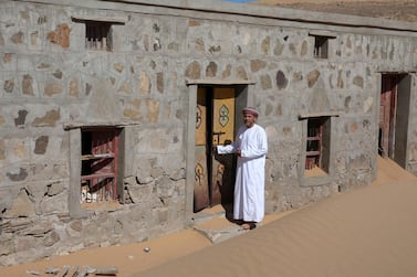 Mohammed al-Ghanbousi, a former inhabitant of Wadi al-Murr, stands next to his abandoned house in the Omani village, about 400km (250 miles) southwest of the capital Muscat. AFP