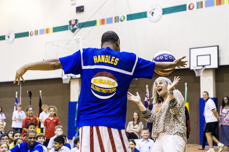 Handles from the Harlem Globetrotters shows off his basketball skills in front of more than 500 pupils at Dubai International Academy.  Reem Mohammed / The National