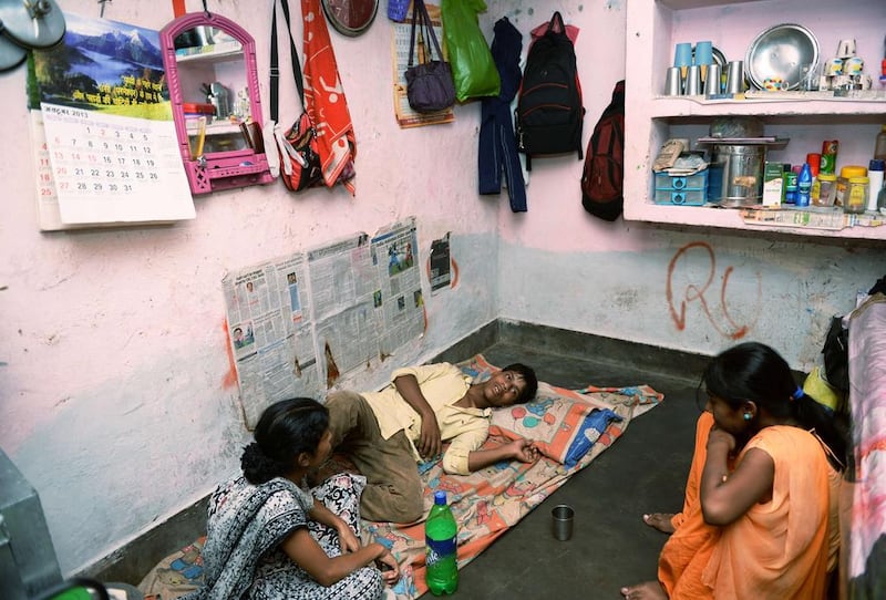 Mohammad Awwal, 19, who has dengue fever, rests at home in New Delhi. Manan Vatsyayana / AFP

