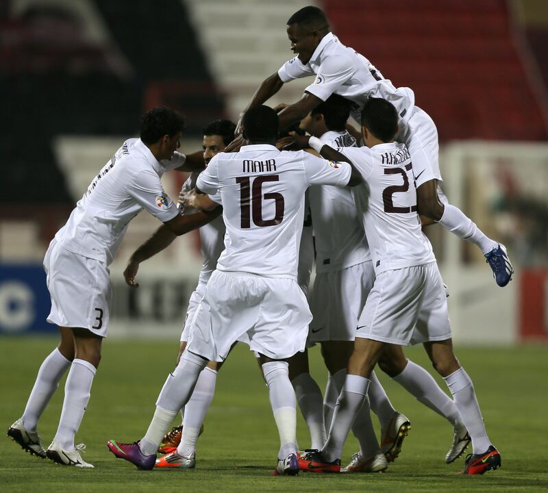 Qatar's Al-Jaish players celebrate after scoring a goal against UAE's Al-Jazira club during their AFC Champions League soccer match in Doha on April 2, 2013. AFP PHOTO /AL-WATAN DOHA / KARIM JAAFAR == QATAR OUT
 *** Local Caption ***  825245-01-08.jpg