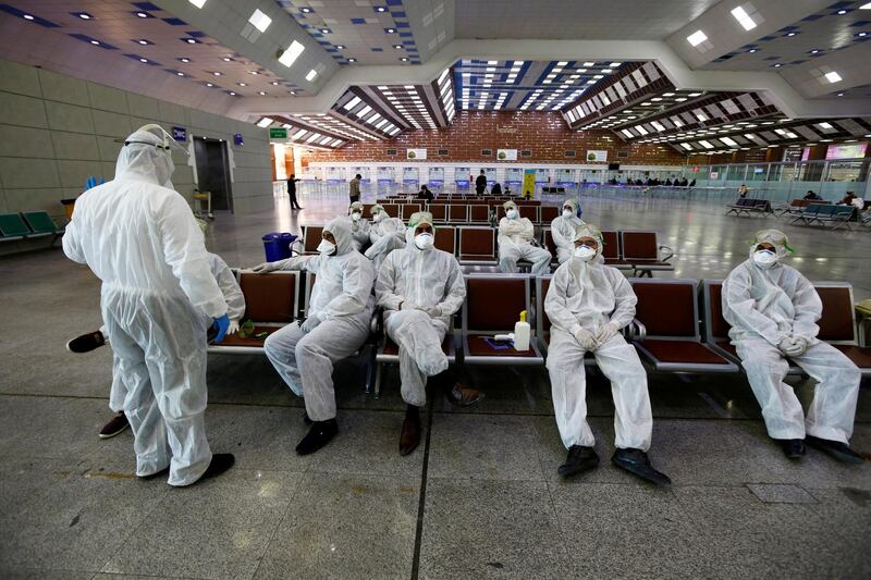 Iraqi medical staff rest after checking passengers' temperature, amid coronavirus outbreak, at Najaf airport, Iraq. REUTERS