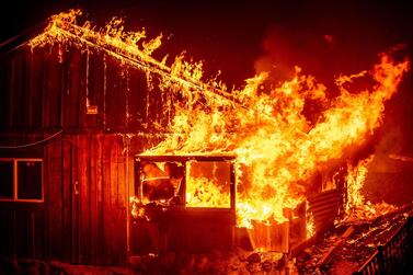 Flames shoot from a home as the Bear Fire burns through the Berry Creek area of Butte County, California on September 9, 2020. AP Photo