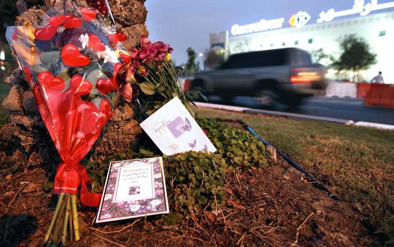 Floral tributes are still left where three young sisters were killed on Airport Road outside Carrefour, Abu Dhabi. Stephen Lock / The National