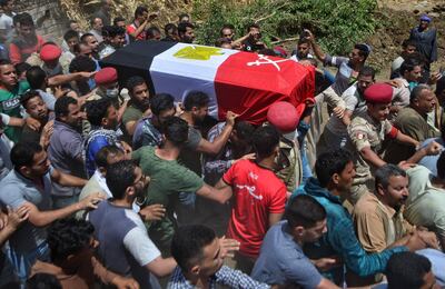 Mourners carry the coffin of Alaa Emad, an Egyptian soldier who was killed in an explosion targeting an armoured vehicle near Bir al-Abed in North Sinai, during his funeral in the vilage of Abwan in the Minya province on May 1, 2020. Egypt's army said Thursday that 10 soldiers, including an officer, were killed or wounded in an explosion that day targeting an armoured vehicle near Bir al-Abed in North Sinai. The Egyptian army killed two suspected jihadists Friday in restive North Sinai, a day after a blast targeted an armoured vehicle, a military spokesman said.
 / AFP / Mohamed Hakim
