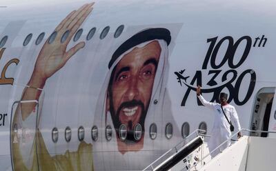 A visitor poses for a photo in front of an Emirates A380 Airbus passenger aircraft decorated with a giant portrait of UAE founding father Zayed bin Sultan Al Nahyan, to celebrate the centenary of his birth, at the ILA Berlin International Aerospace Exhibition at Schoenefeld airport near Berlin on April 25, 2018.
According to the organisers, over 1,000 exhibitors will showcase their expertise – from civil aviation to defense, security and space, and from major corporations to highly specialized suppliers. The fair is running from April 25 to 29, 2018. / AFP PHOTO / John MACDOUGALL