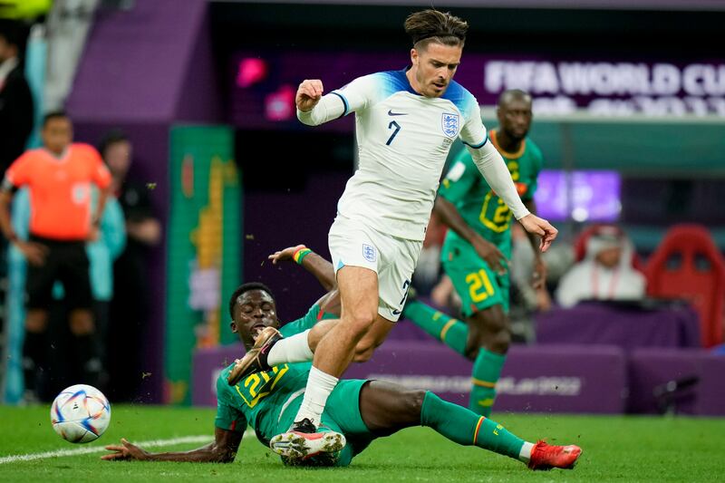 England's Jack Grealish and Senegal's Bamba Dieng battle. AP 