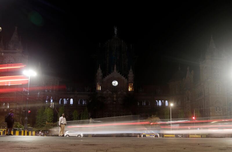 Mumbai's historic railway station Chhatrapati Shivaji Maharaj Terminus is seen in the background from the streets as lights were switched off for Earth Hour, in India. AP