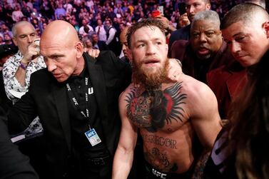 Conor McGregor is escorted from the cage area after fighting Khabib Nurmagomedov. AP Photo
