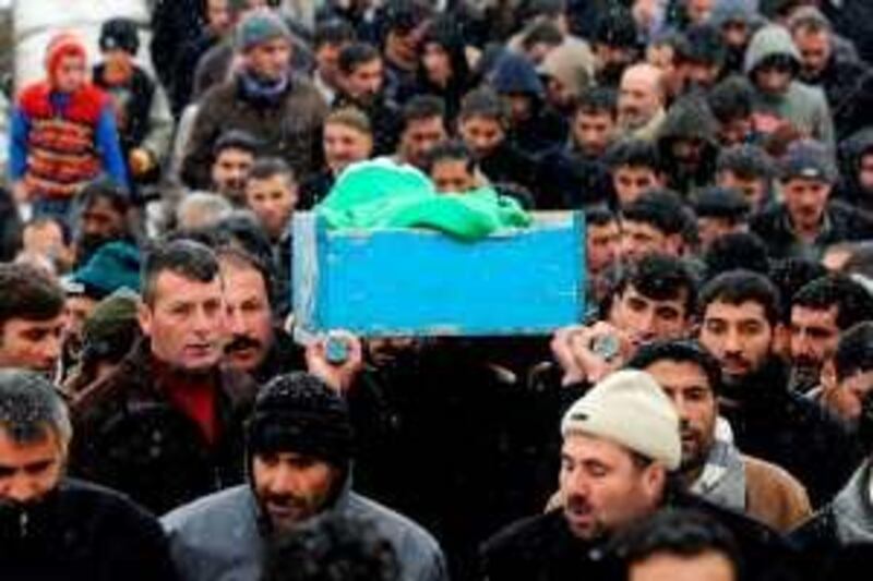 Kurdish people carry the coffin of Necmi Oral during funeral ceremony in Bulanik town of Mus province, on December 16, 2009. Two people were shot dead and several were wounded on December 15, 2009 during a Kurdish demonstration in southeastern Turkey on the fifth day of unrest triggered by a court ban on the country's main Kurdish party. AFP PHOTO / MUSTAFA OZER *** Local Caption ***  460981-01-08.jpg