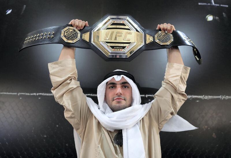 Abu Dhabi, United Arab Emirates - September 06, 2019: Fight fan Yousif Ismamailov holds up the belt at the UFC fan zone. Friday the 6th of September 2019. Yes Island, Abu Dhabi. Chris Whiteoak / The National