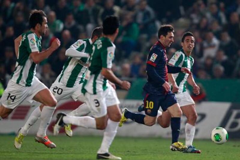 Barcelona's Lionel Messi is pursued by Cordoba players as he heads towards goal.