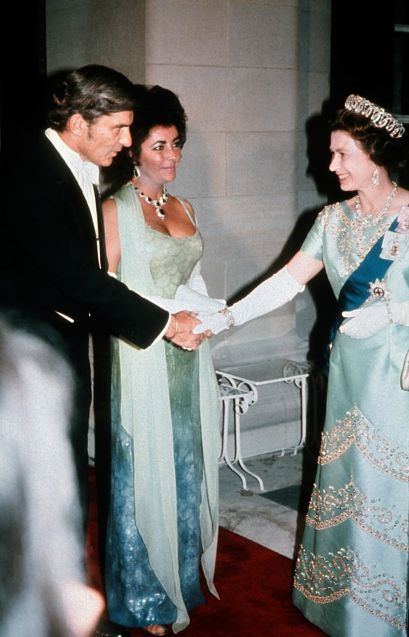 Queen Elizabeth ll meets Liz Taylor and husband John Warner at a gala dinner in 1976 in Washington. Getty Images