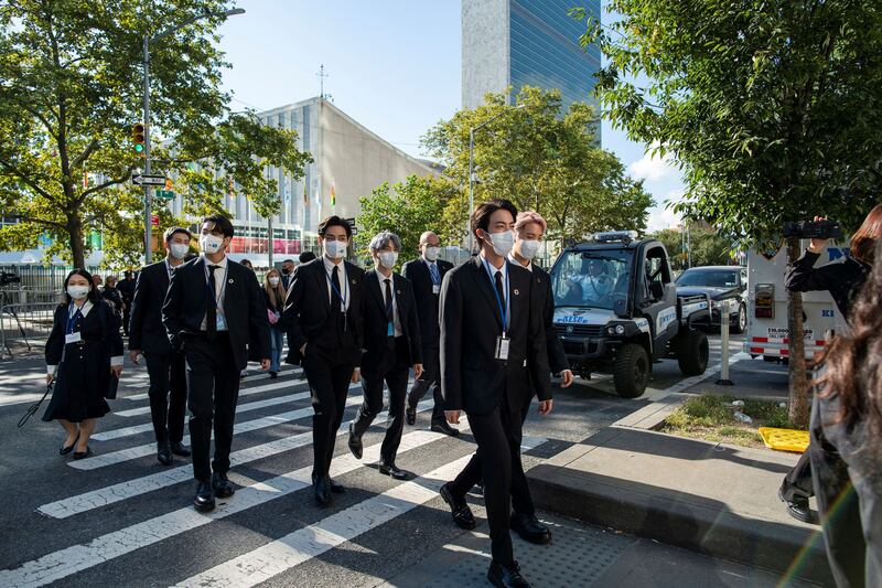 Members of BTS walk near the United Nations headquarters during the 76th United Nations General Assembly in Manhattan, New York. Reuters