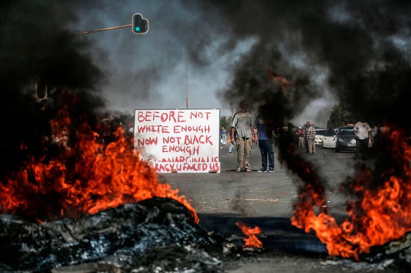 Community members burn tyres to protest the lack of police and government action against social issues in Johannesburg's Ennerdale suburb, South Africa. AFP