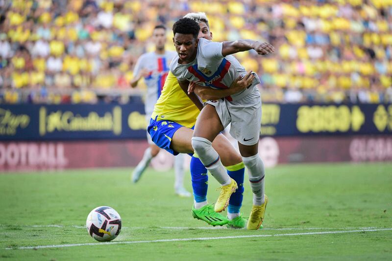 Cadiz midfielder Ivan Alejo fights for the ball with Barcelona's Spanish defender Alejandro Balde. AFP