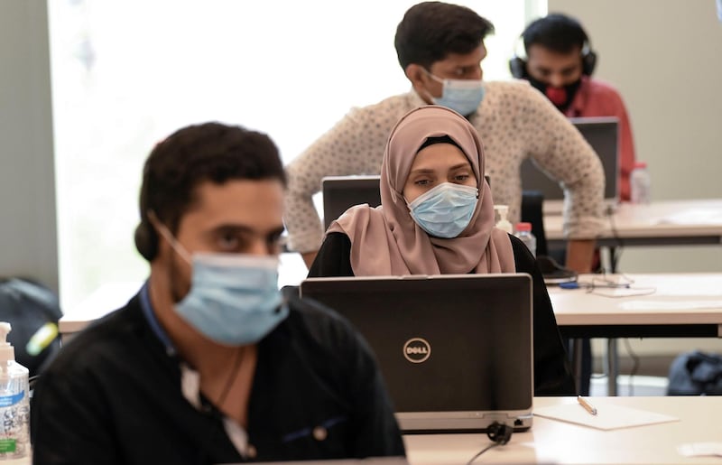 Operators man their posts at Dubai's COVID-19 Command and Control Centre at Mohammed bin Rashid University, in the United Arab Emirates, on June 1, 2020. The platform is tasked with planning and managing the Gulf emirate's response to the novel coronavirus pandemic. / AFP / Karim SAHIB
