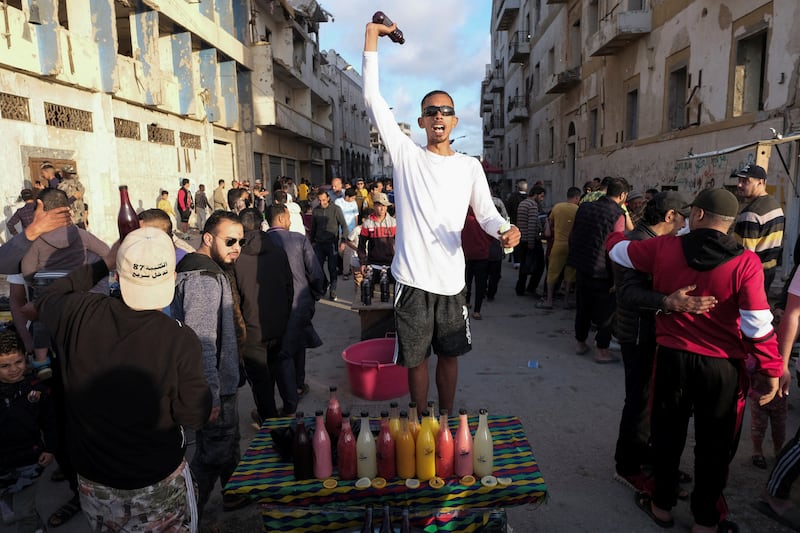 A man holds a juice bottle at a market in Benghazi. Reuters