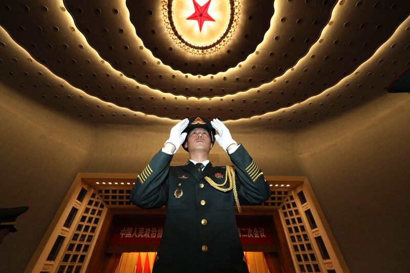 A Chinese military band conductor leads the band to rehearse before the opening session of the Chinese People's Political Consultative Conference, in Beijing's Great Hall of the People. AP Photo